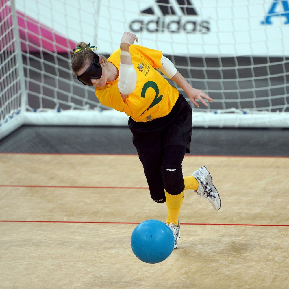 Tyan Taylor competing in goalball in the 2012 Paralympic Games. Gold Australian Paralympic Team shirt, green number 2.