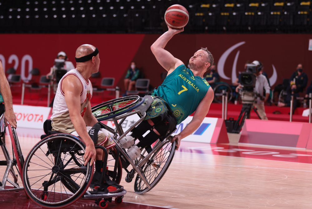 Shaun Norris shooting the basketball while balancing on one wheel