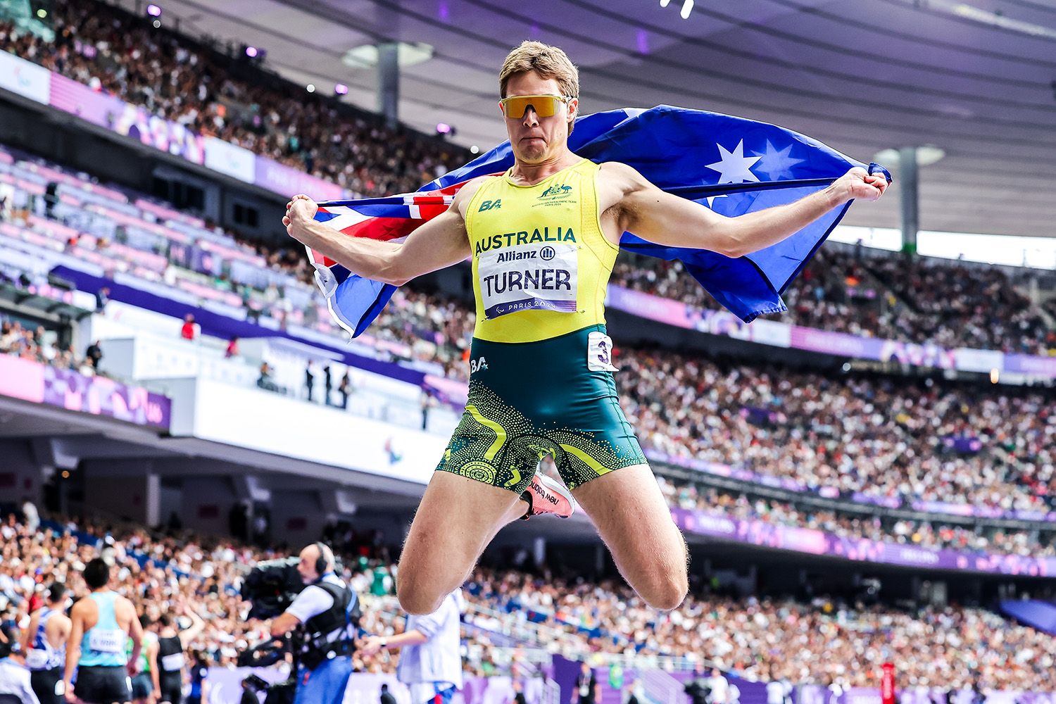 James Turner celebrates after winning the 100m T36